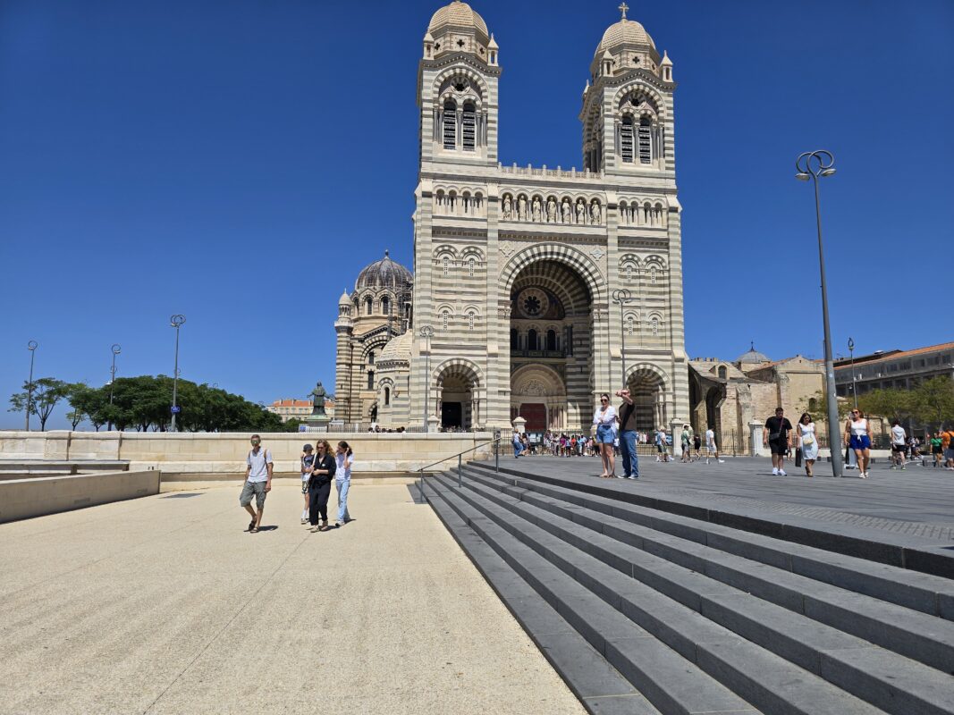 Tourists walking near Cathédrale de la Major, a key cultural site in Marseille, France.