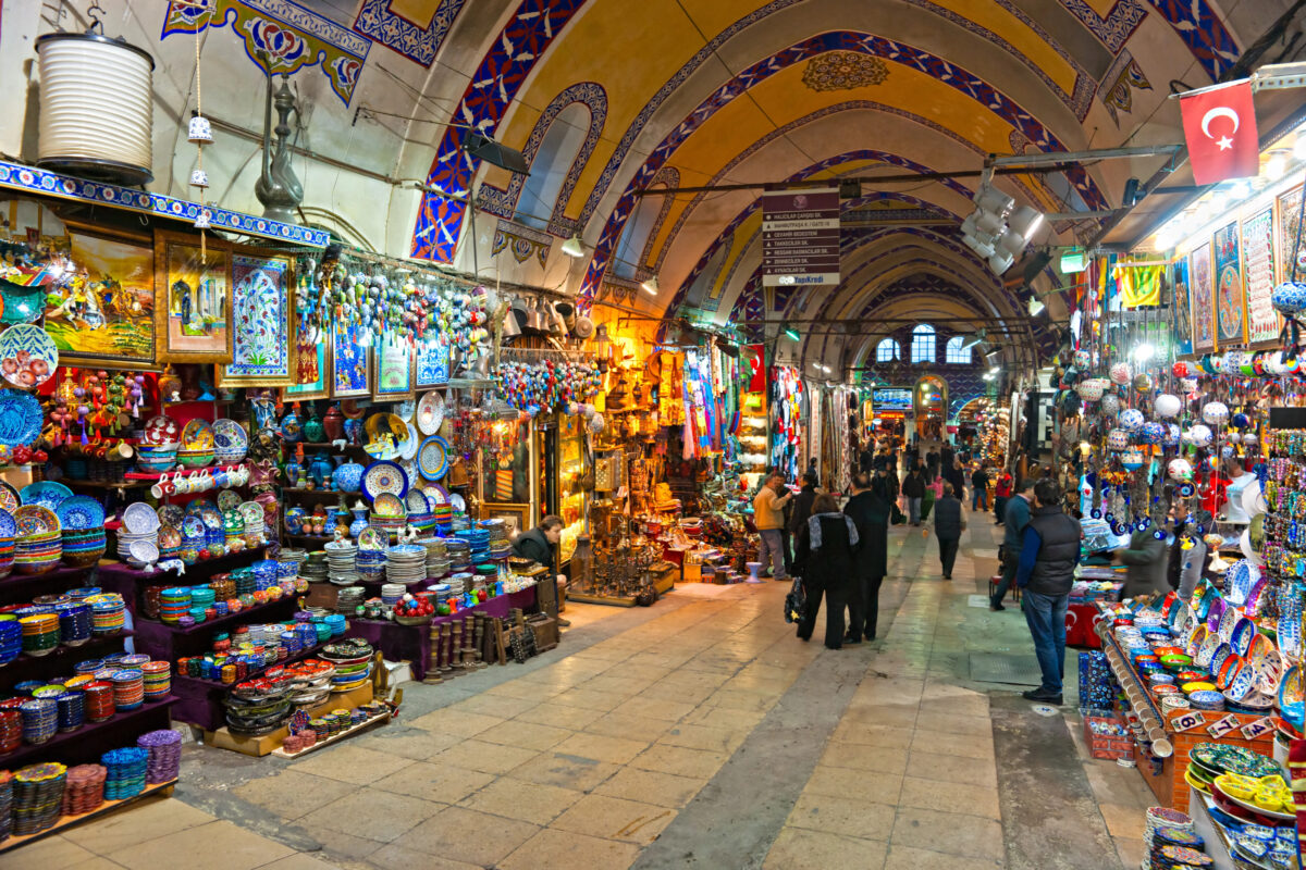 Colorful stalls inside Istanbul’s Grand Bazaar, filled with ceramics, textiles, and lanterns.