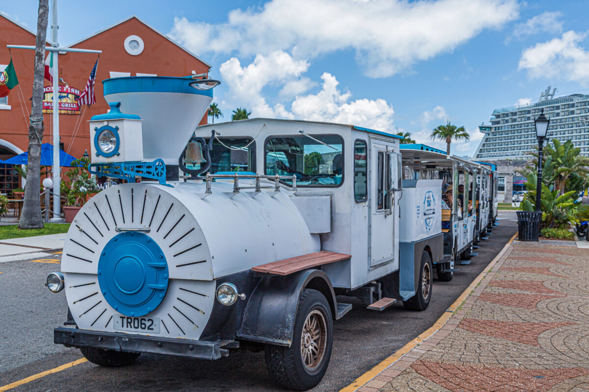 Dockyard Shuttle Train in Bermuda waiting for passengers near shops and restaurants at the main cruise pier.