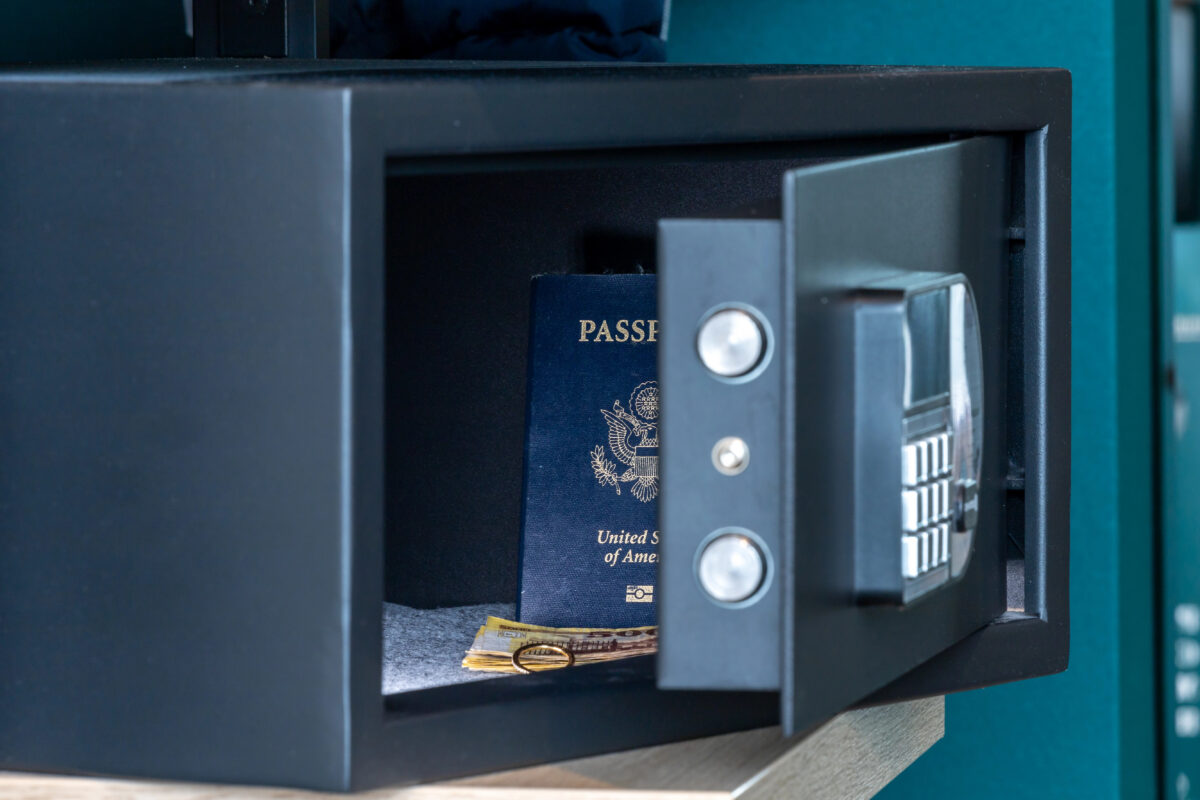 Are cruise ships safe | Digital keypad safe left open with passport and currency inside, showing how travelers can protect valuables in a stateroom.