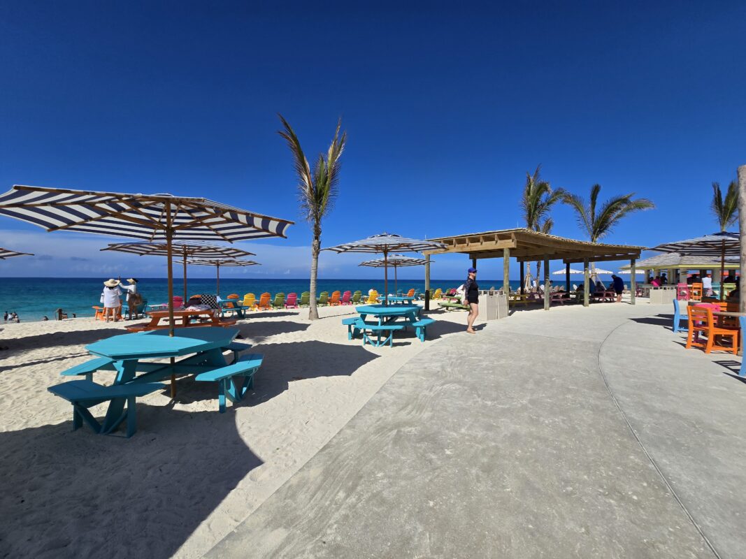 Scenic seating and picnic tables at Royal Beach Club Paradise Island beside the beach and close to food stations.