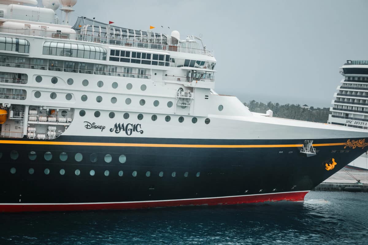 Close-up of the bow of Disney Magic (one of today's oldest cruise ships still in service) docked in Nassau, with MSC Divina visible behind it.